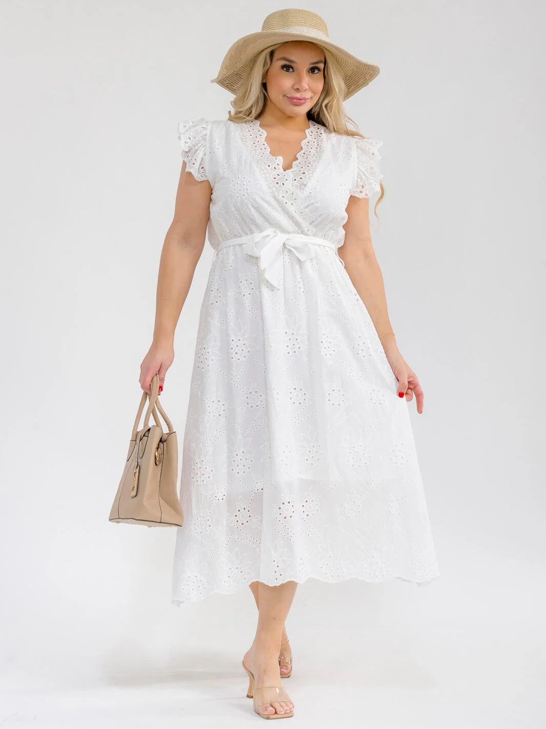 Plus Size Ruffle Sleeve Surplice Elastic Waist Eyelet Maxi Dress worn with a hat and handbag in a stylish pose.